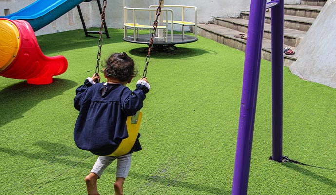 A child swings in a commercial playground