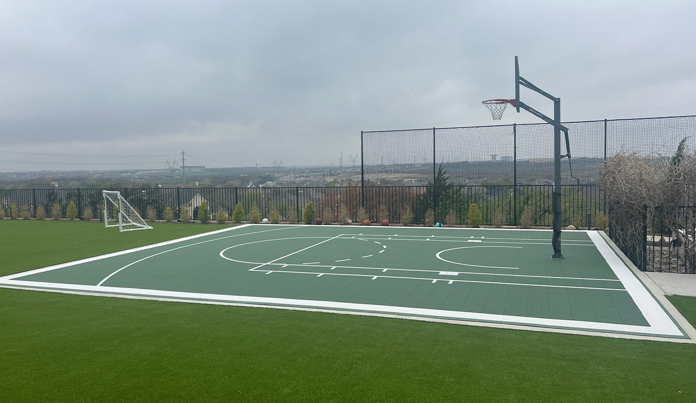 Backyard basketball court with artificial grass