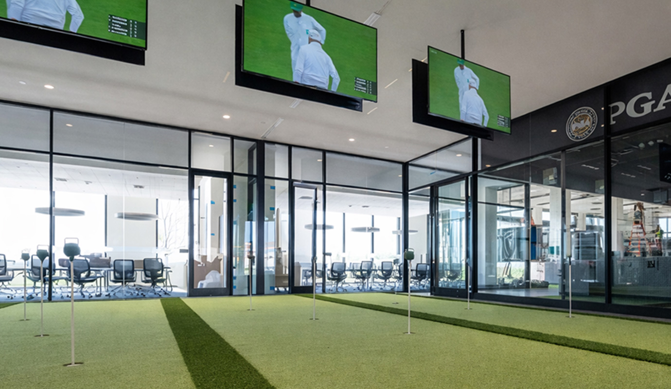 An indoor putting green featuring artificial grass for golf practice