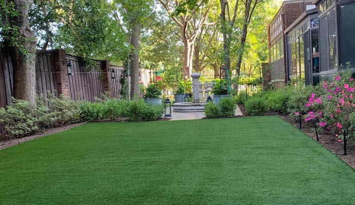 A residential backyard with artificial grass