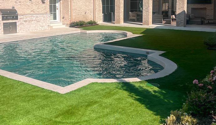 Residential pool area with installed artificial turf